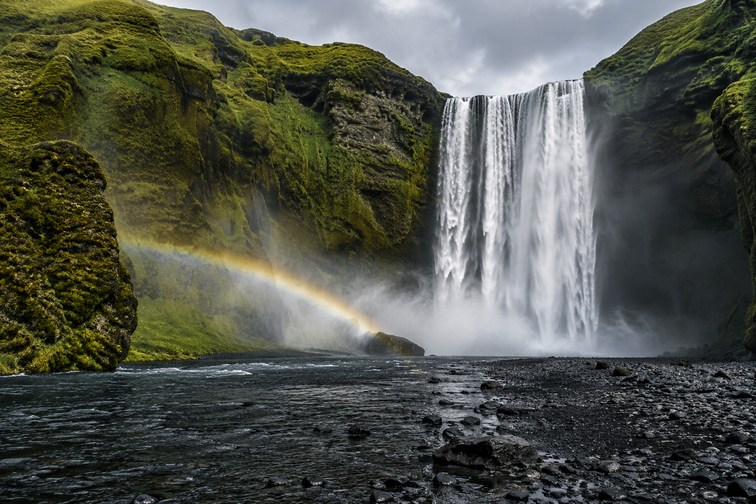 Waterfall flowing down a moss-covered cliff